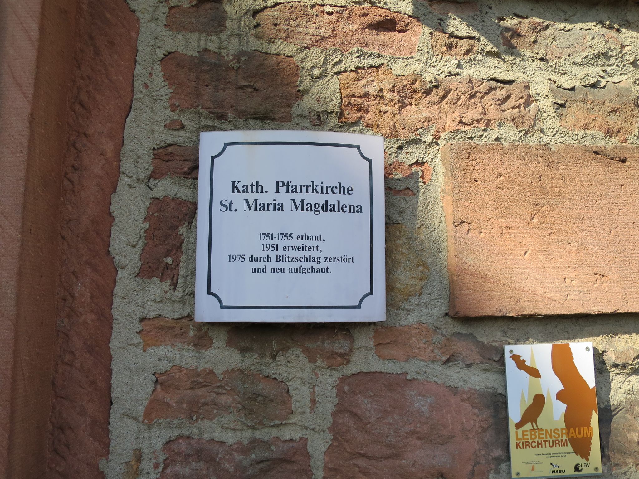 Hinweisschild am Haupteingang der Pfarrkirche